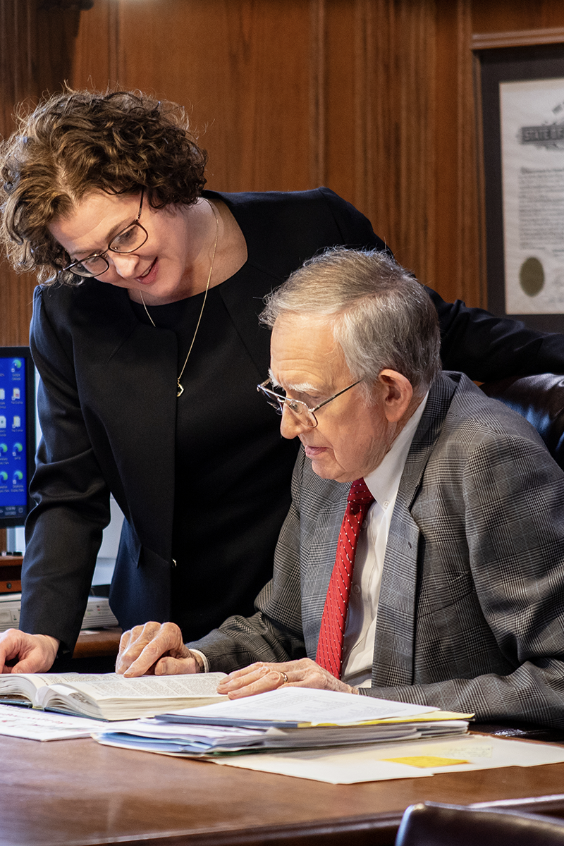 Posey and Perkins review documents in the office